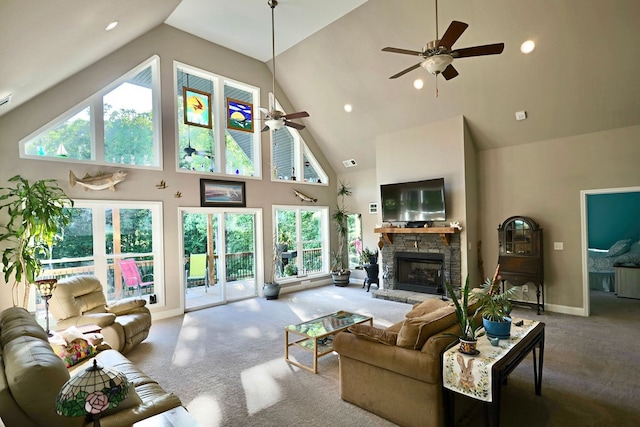 carpeted living room featuring high vaulted ceiling and a healthy amount of sunlight