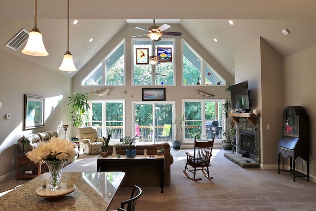 living room with high vaulted ceiling, ceiling fan, carpet floors, and a fireplace