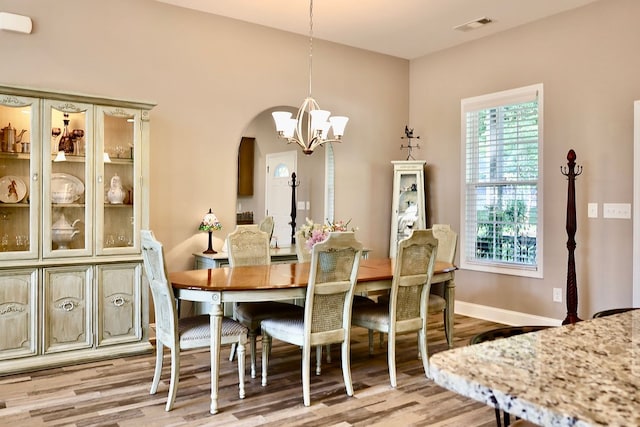 dining area with a chandelier and hardwood / wood-style floors