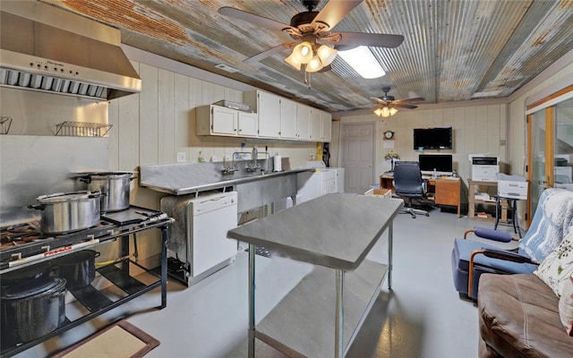 kitchen with ceiling fan, white cabinets, wooden walls, extractor fan, and high end stainless steel range oven