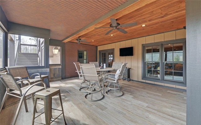 exterior space with wood ceiling, beam ceiling, and ceiling fan