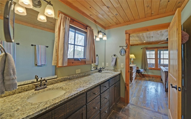 bathroom with wood ceiling, wood-type flooring, a healthy amount of sunlight, and vanity