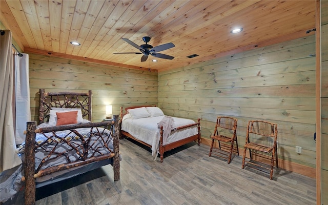 bedroom featuring wood-type flooring, wood ceiling, wood walls, and ceiling fan