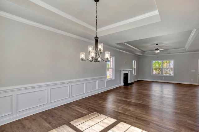 unfurnished living room featuring hardwood / wood-style flooring, a raised ceiling, and crown molding