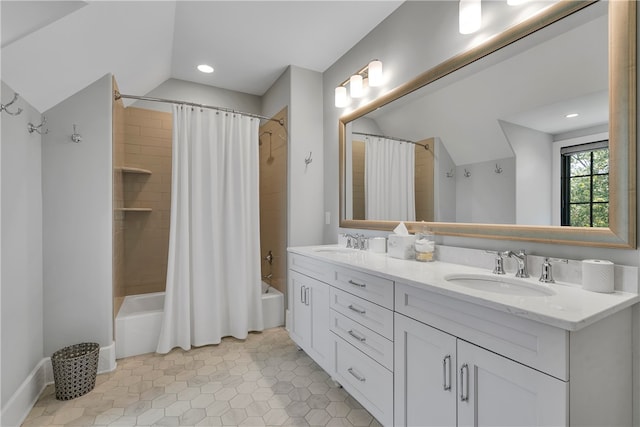 bathroom featuring tile patterned flooring, lofted ceiling, shower / bath combo, and vanity