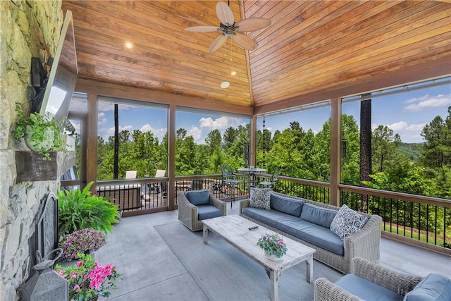 sunroom / solarium with ceiling fan, lofted ceiling, and wooden ceiling