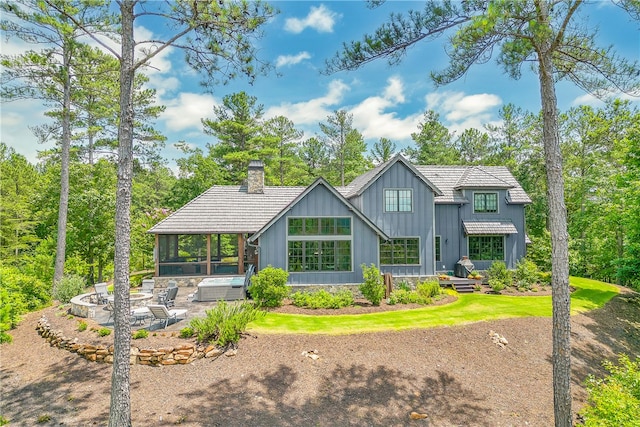 view of front of home featuring a front yard and a sunroom