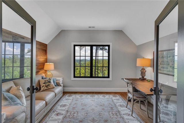 office space featuring lofted ceiling and light hardwood / wood-style floors