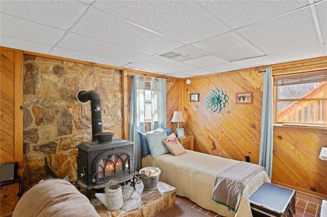 728 Tall Oak Trl, Seneca, SC 29678 - bedroom with wooden walls, a drop ceiling, and a wood stove