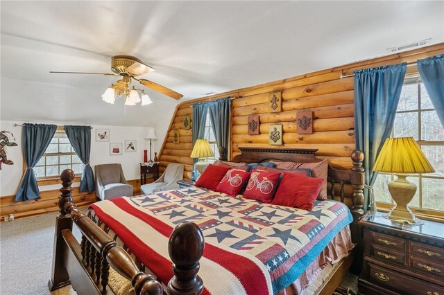 728 Tall Oak Trl, Seneca, SC 29678 - bedroom featuring lofted ceiling, rustic walls, multiple windows, and ceiling fan