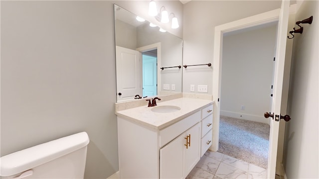 bathroom featuring vanity and toilet