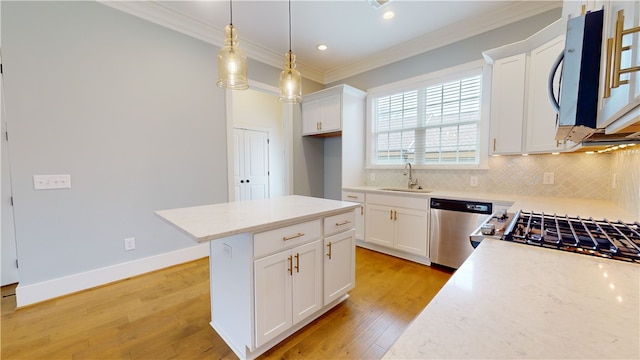 kitchen featuring light wood-type flooring, white cabinetry, decorative light fixtures, and stainless steel appliances