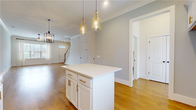 kitchen with a kitchen island, light wood-type flooring, and white cabinetry