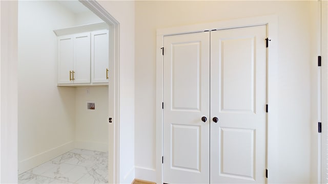 clothes washing area with washer hookup and cabinets