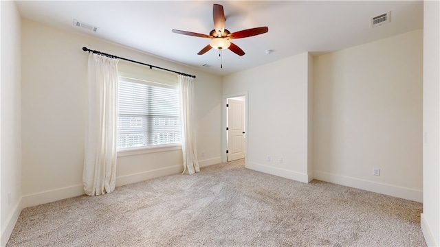 unfurnished room with ceiling fan and light colored carpet