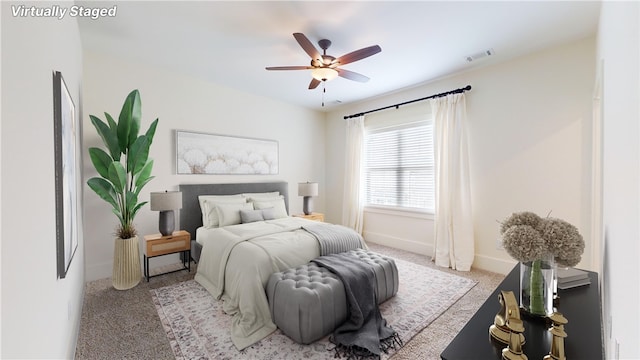 bedroom featuring ceiling fan and light carpet