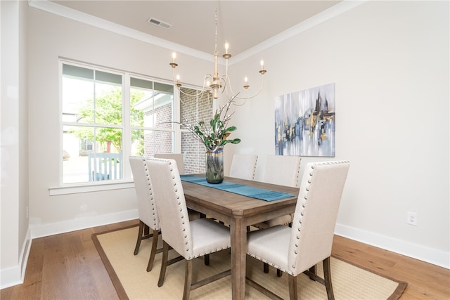 dining area featuring a wealth of natural light, wood-type flooring, and ornamental molding