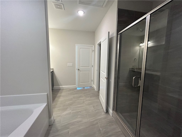 bathroom with shower with separate bathtub and tile patterned floors