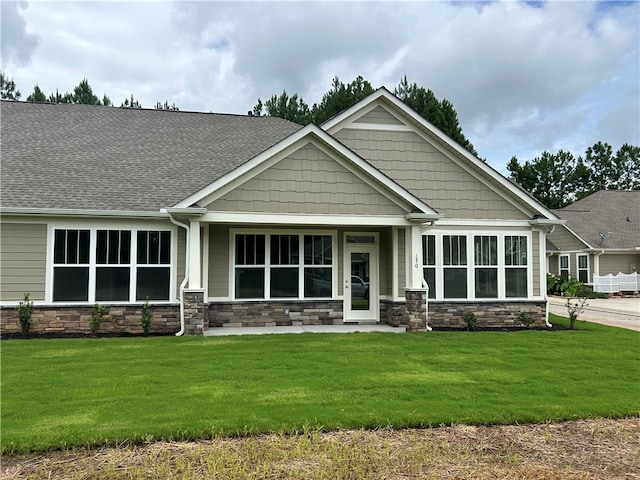 craftsman inspired home with a front yard