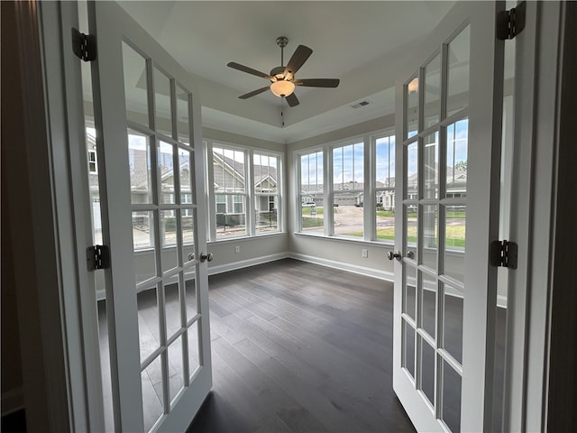 unfurnished sunroom featuring french doors and ceiling fan