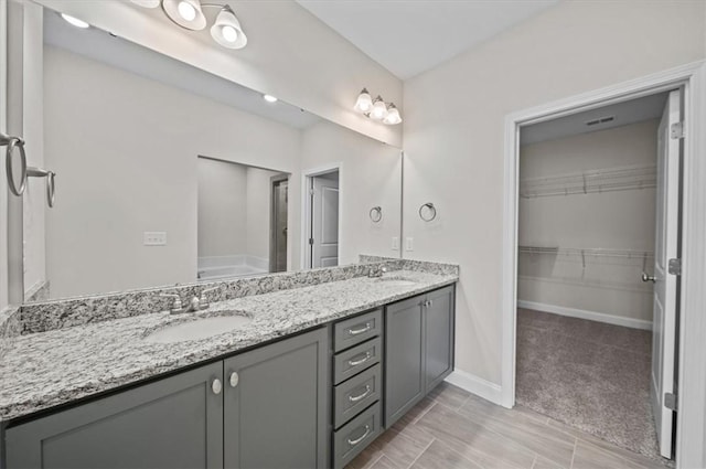 170 Preston Ridge Dr, Seneca, SC 29672 - bathroom with a sink, a spacious closet, baseboards, visible vents, and double vanity