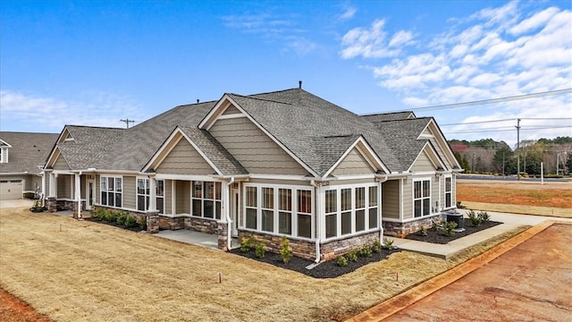 170 Preston Ridge Dr, Seneca, SC 29672 - view of front facade with stone siding, a sunroom, and a shingled roof