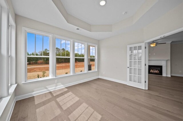 170 Preston Ridge Dr, Seneca, SC 29672 - empty room with baseboards, a fireplace, wood finished floors, a ceiling fan, and a tray ceiling