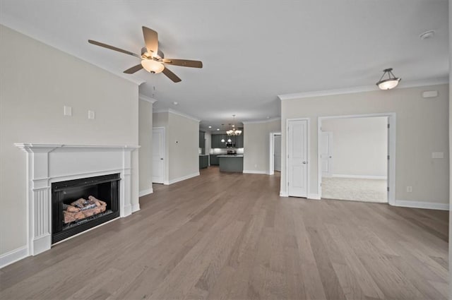 170 Preston Ridge Dr, Seneca, SC 29672 - unfurnished living room with a fireplace, wood finished floors, ceiling fan with notable chandelier, and ornamental molding
