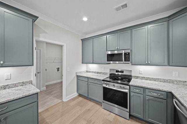 170 Preston Ridge Dr, Seneca, SC 29672 - kitchen featuring crown molding, light wood-type flooring, stainless steel appliances, light stone counters, and visible vents