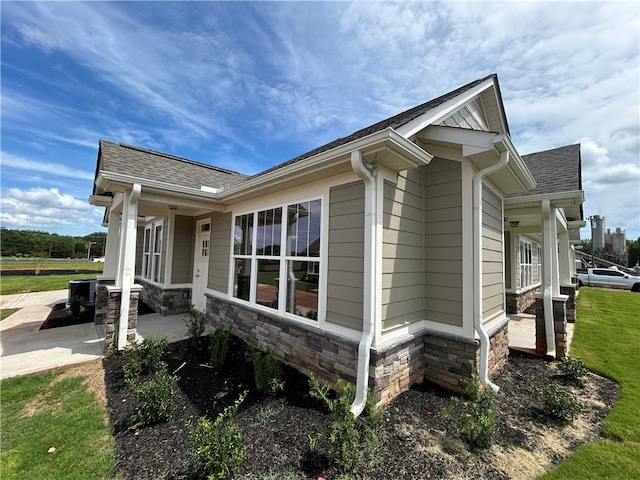 view of side of home with a yard