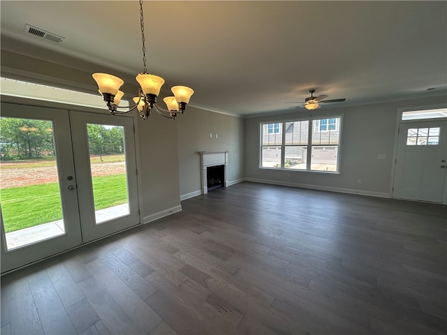 unfurnished living room with crown molding, ceiling fan with notable chandelier, dark hardwood / wood-style flooring, and french doors