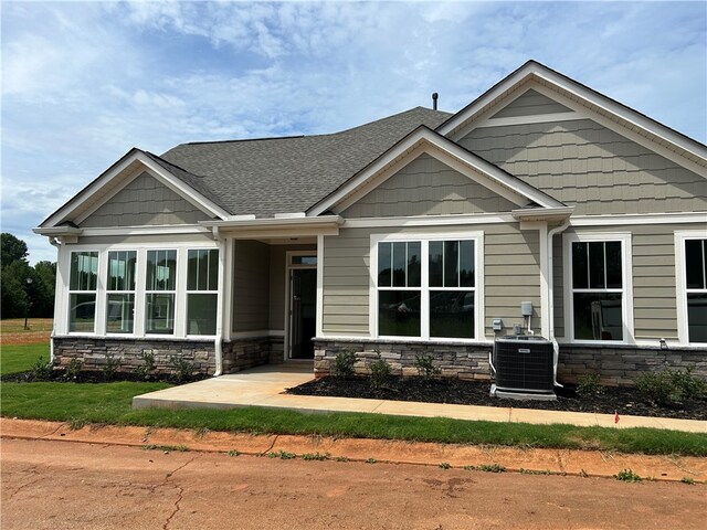 craftsman-style house featuring central AC