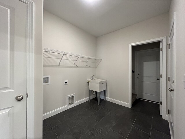 clothes washing area with hookup for a washing machine, dark tile patterned flooring, and electric dryer hookup