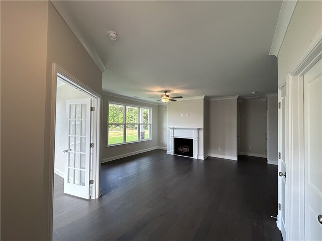 unfurnished living room with ceiling fan, dark hardwood / wood-style floors, and crown molding