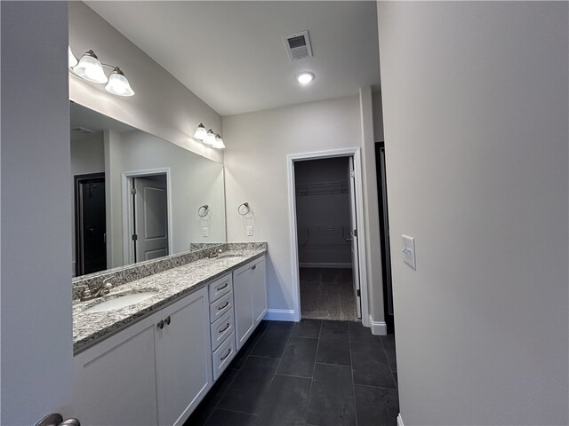 bathroom with tile patterned floors and vanity