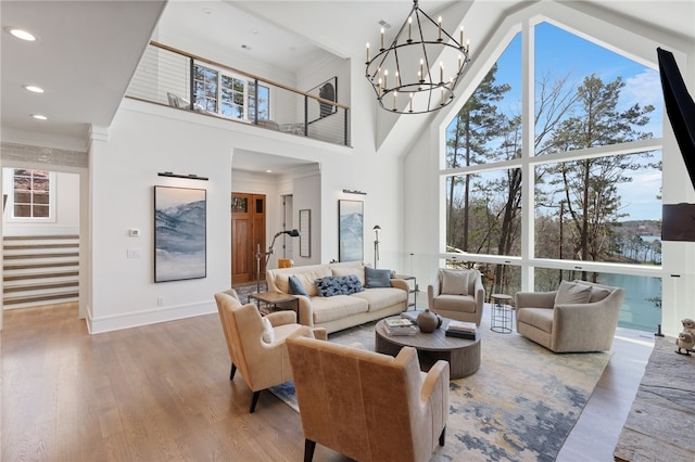 living room featuring a high ceiling, ornamental molding, and hardwood / wood-style floors