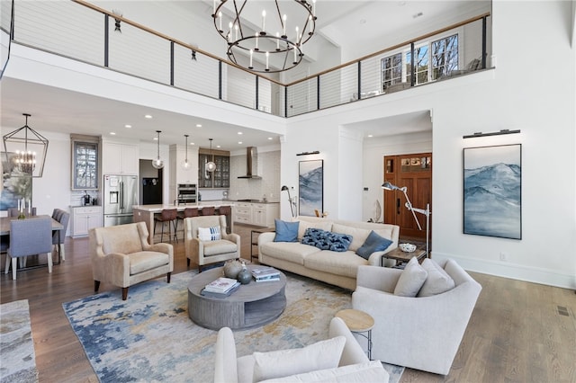 living room with a chandelier, a high ceiling, and dark wood-type flooring