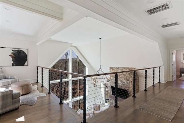 hallway featuring dark hardwood / wood-style flooring, lofted ceiling with beams, and an inviting chandelier