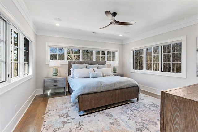 bedroom featuring ceiling fan, hardwood / wood-style floors, and crown molding