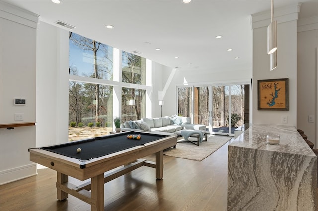 rec room featuring hardwood / wood-style floors, expansive windows, a wealth of natural light, and pool table