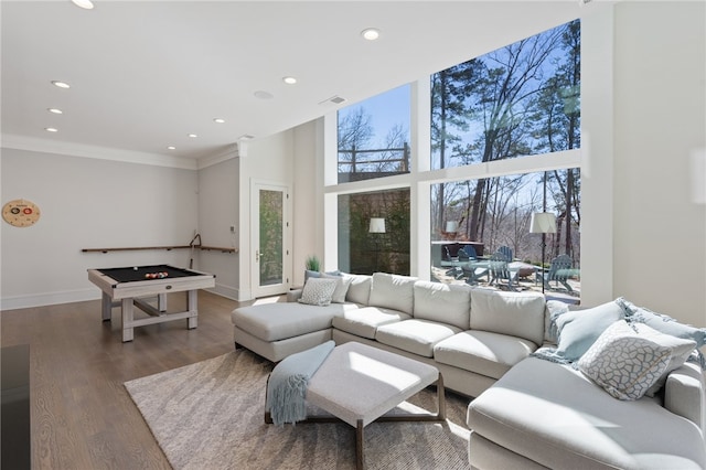 living room featuring pool table, a high ceiling, and hardwood / wood-style flooring