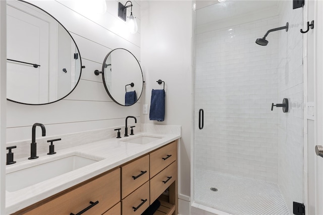 bathroom featuring wood walls, vanity, and a shower with shower door