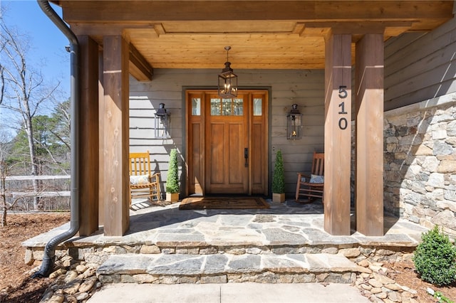 view of exterior entry with covered porch