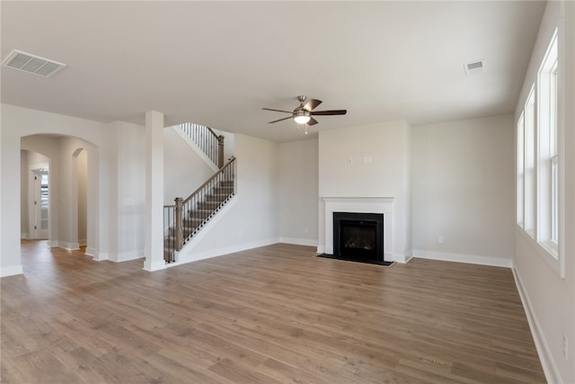 unfurnished living room with wood-type flooring and ceiling fan