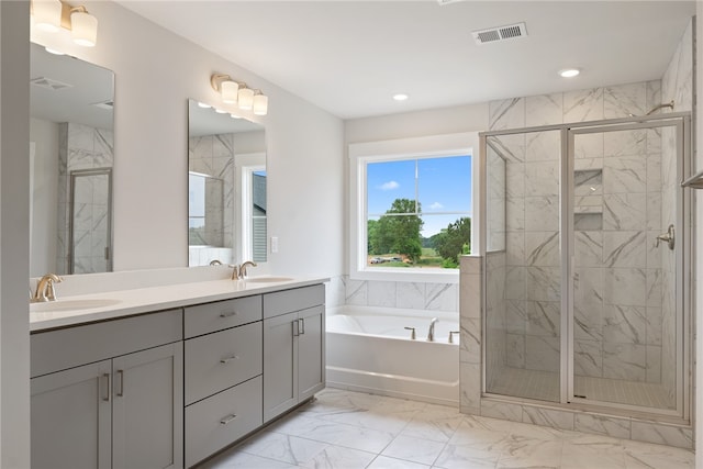 bathroom featuring vanity and separate shower and tub