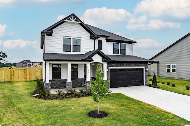 view of front of property featuring a garage and a front lawn