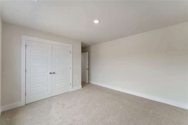 unfurnished bedroom featuring a closet and carpet flooring