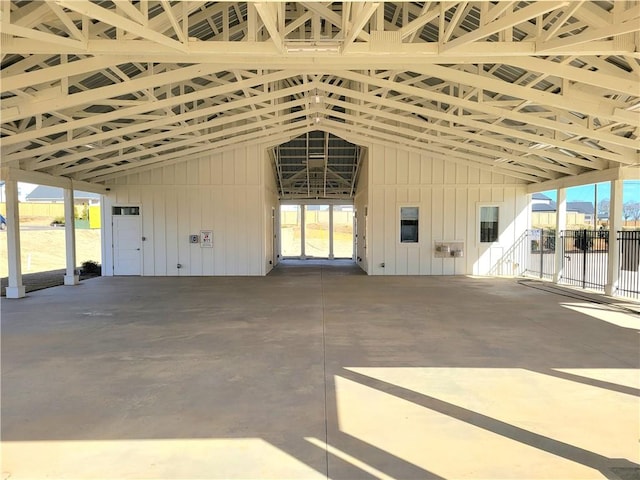 interior space featuring a towering ceiling and wood walls