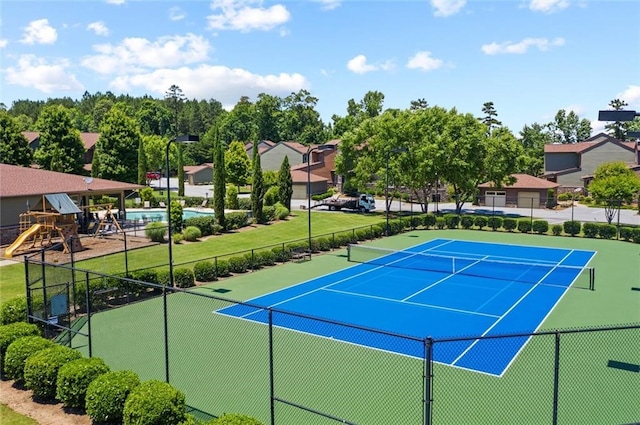 view of sport court featuring a playground and a covered pool