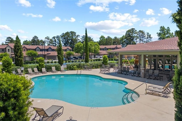 view of swimming pool with a patio